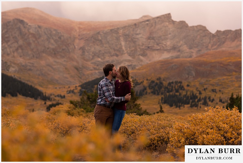 fall engagement photos in colorado fall colors everwhere and groom kisses his wife