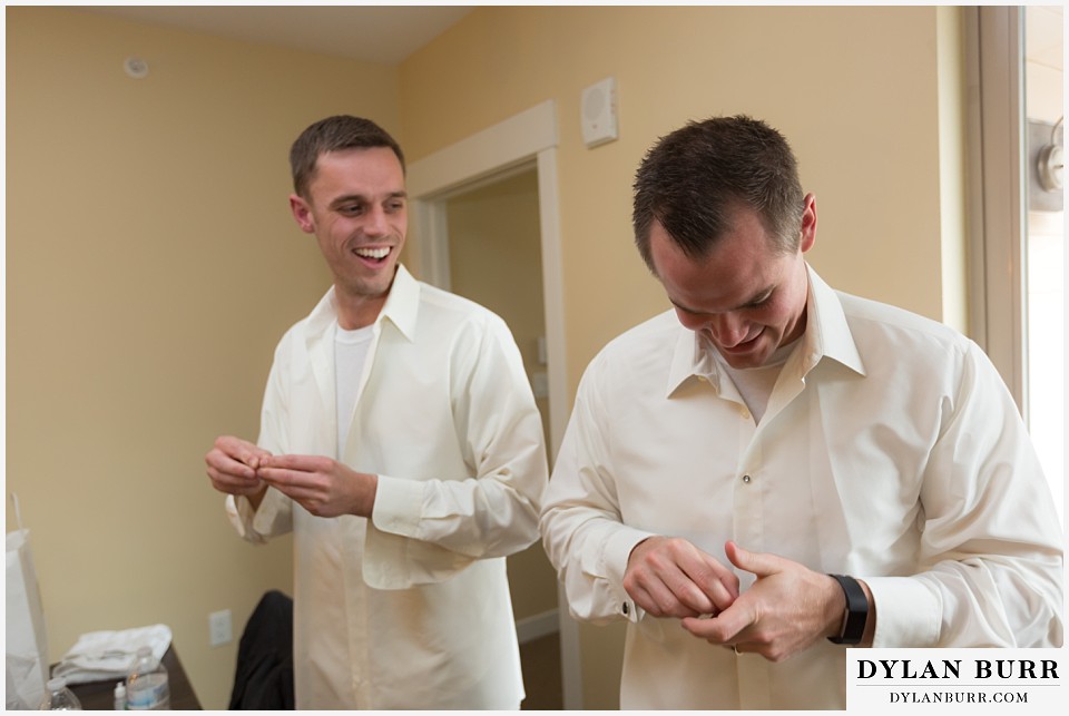 the lodge at sunspot wedding winter park groomsmen getting ready laughing