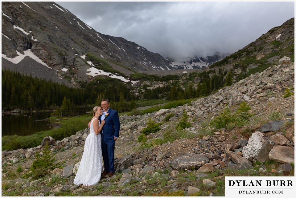 breckenridge blue lakes elopement wedding colorado couple laughing together by mountain lake