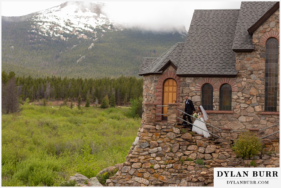 camp st malo wedding allenspark colorado estes park mountain wedding bride and groom walking near chapel