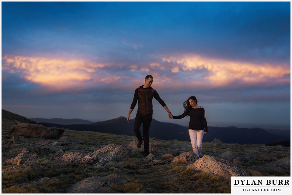 how to prepare for my engagement session couple walking together on top of mountains