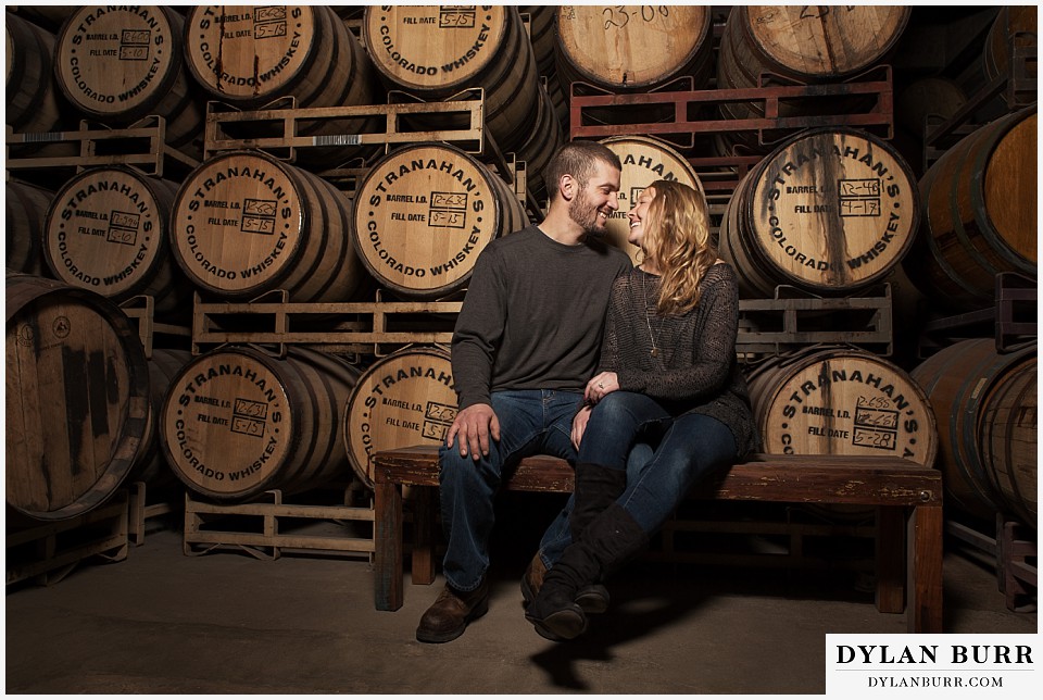 how to prepare for my engagement session couple stranahans whiskey tour near wall of barrels