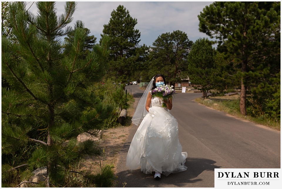intimate wedding elopement sprague lake rocky mountain national park bride in mask walking