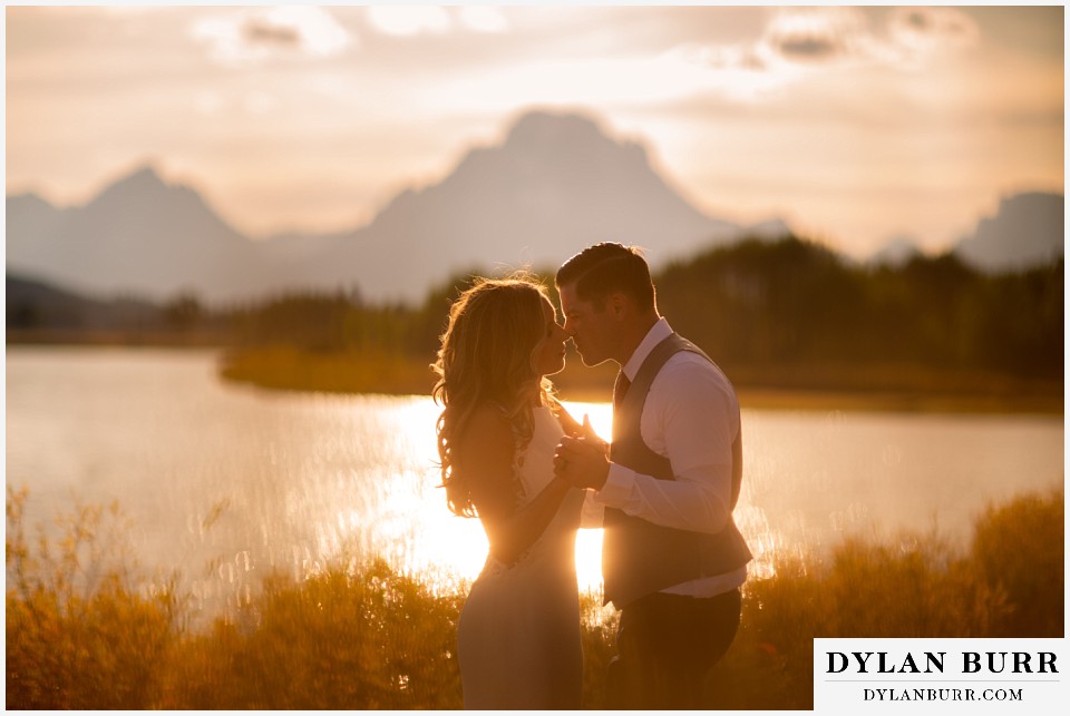jackson lake lodge wedding grand tetons wyoming bride and groom going in close for a kiss at sunset
