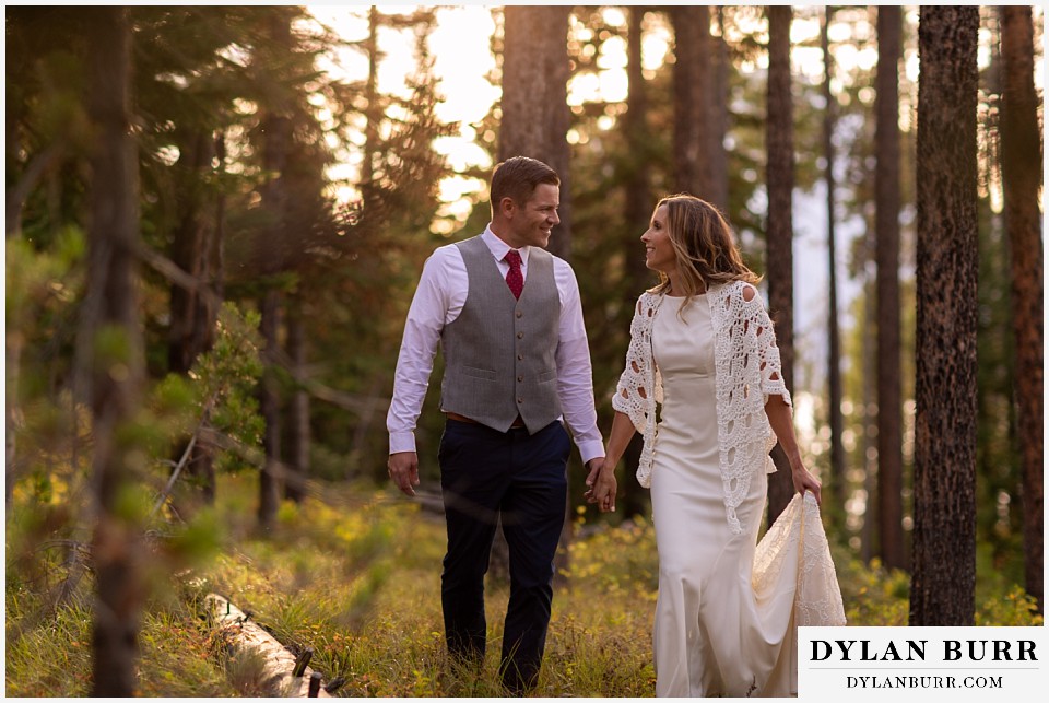 jackson lake lodge wedding grand tetons wyoming bride and groom in forest at sunset