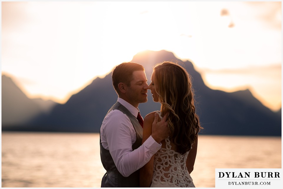 jackson lake lodge wedding grand tetons wyoming bride and groom going in for a kiss at sunset near Jackson lake