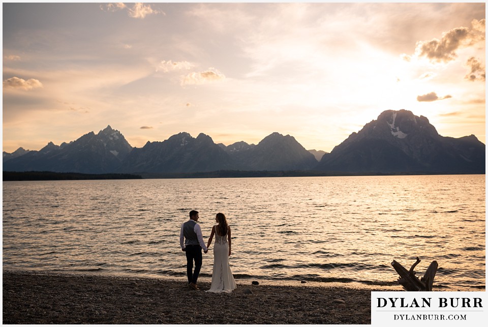 jackson lake lodge wedding grand tetons wyoming bride and groom at sunset with grand teton and mt moran in background