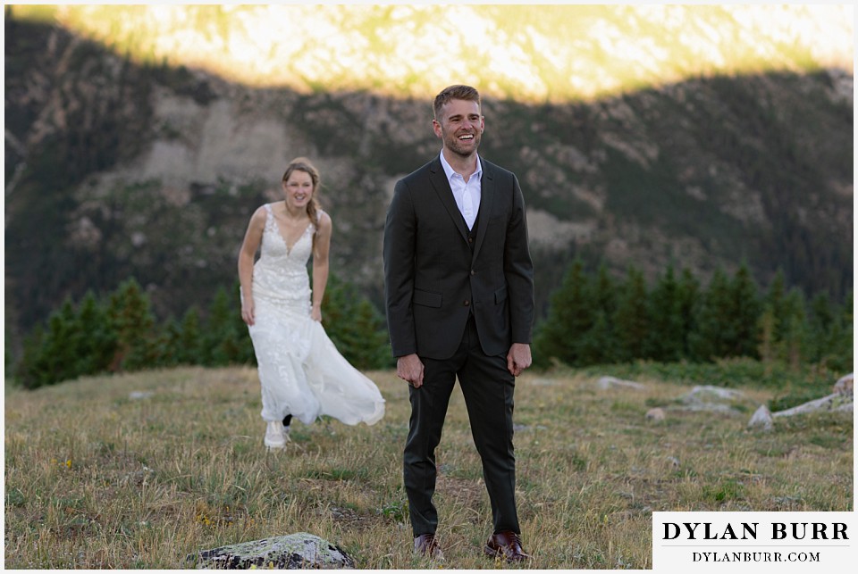 sunrise elopement wedding bride hiking up to groom for first look