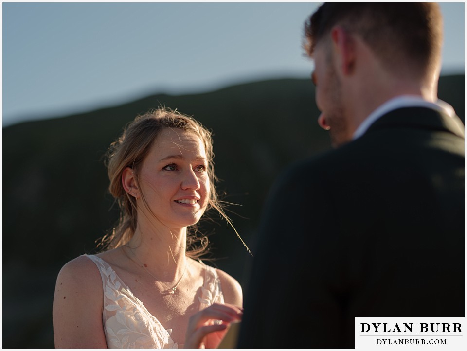 sunrise elopement wedding emotional bride as she reads her vows to her husband
