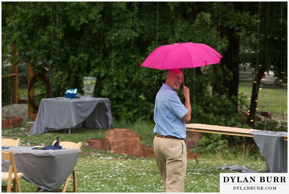 lyons farmette wedding a wedding guest braving it with an umbrella