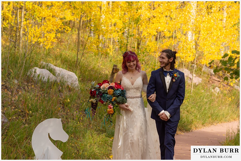 maroon bells wedding aspen colorado mountain wedding bride and groom walking together fall aspen colors