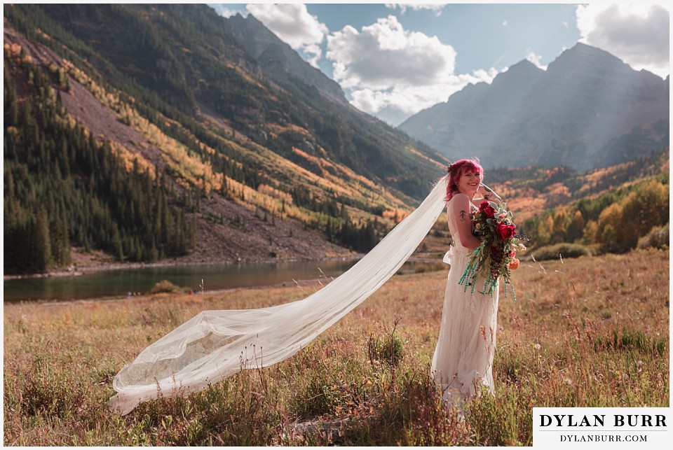 maroon bells wedding aspen colorado mountain wedding bride in field with long veil