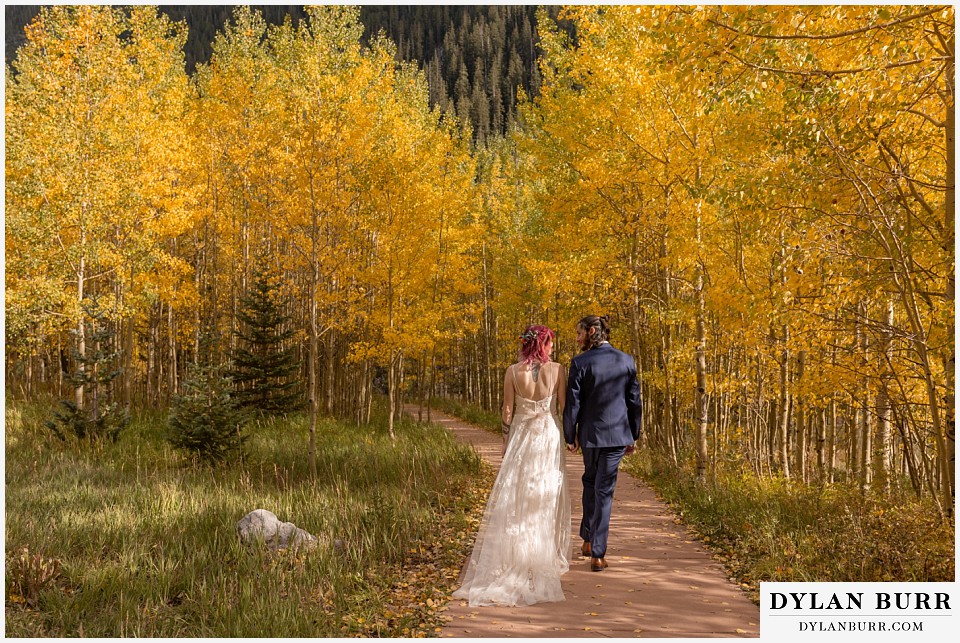 maroon bells wedding aspen colorado mountain wedding bride and groom in trees walking