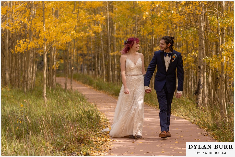 maroon bells wedding aspen colorado mountain wedding bride and groom smiling in fall aspen leaves