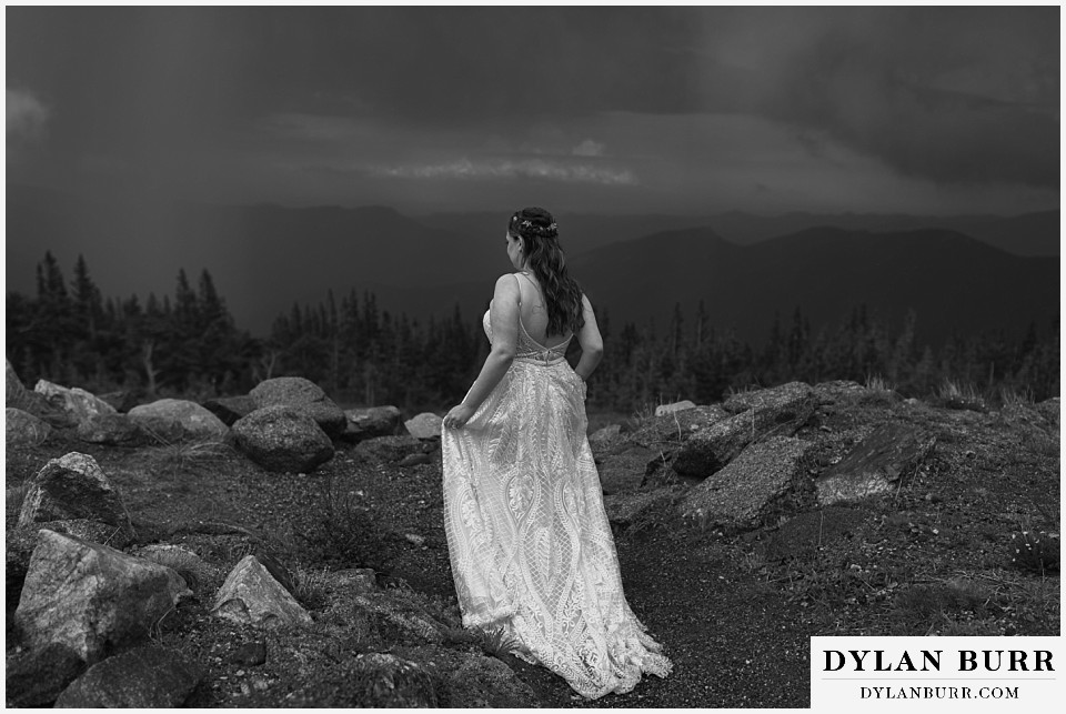 mount blue sky elopement wedding bride in mountains with rain in background