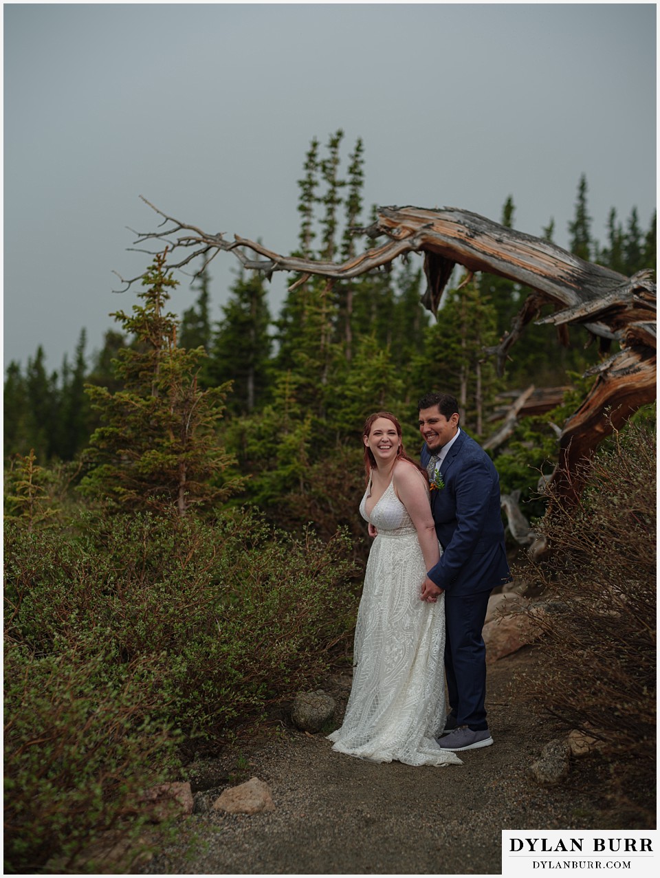 mount blue sky elopement wedding bride and groom laughing in mountains together