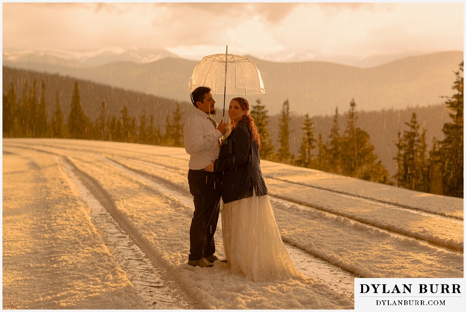 mount blue sky elopement wedding couple at sunset standing in hail storm