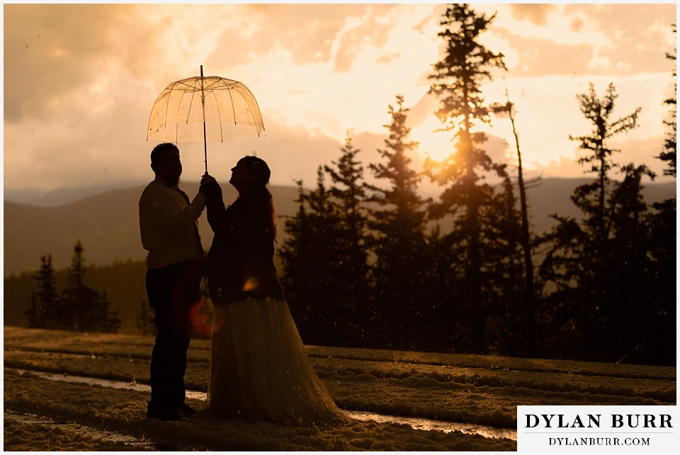 mount blue sky elopement wedding couple in stormy sunset