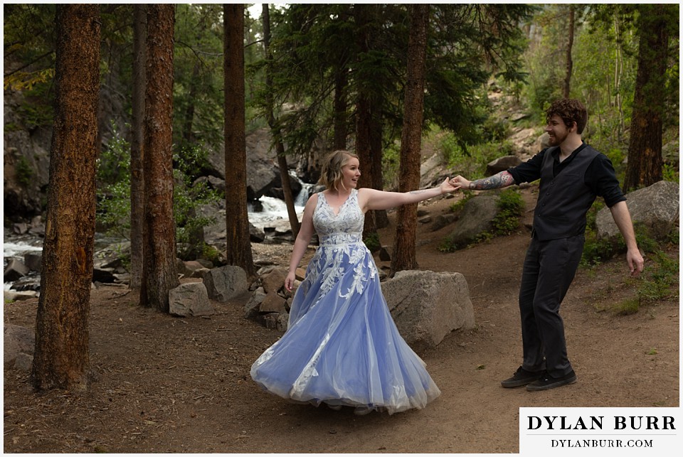 mountain adventure elopement wedding colorado bride and groom dancing in pine trees