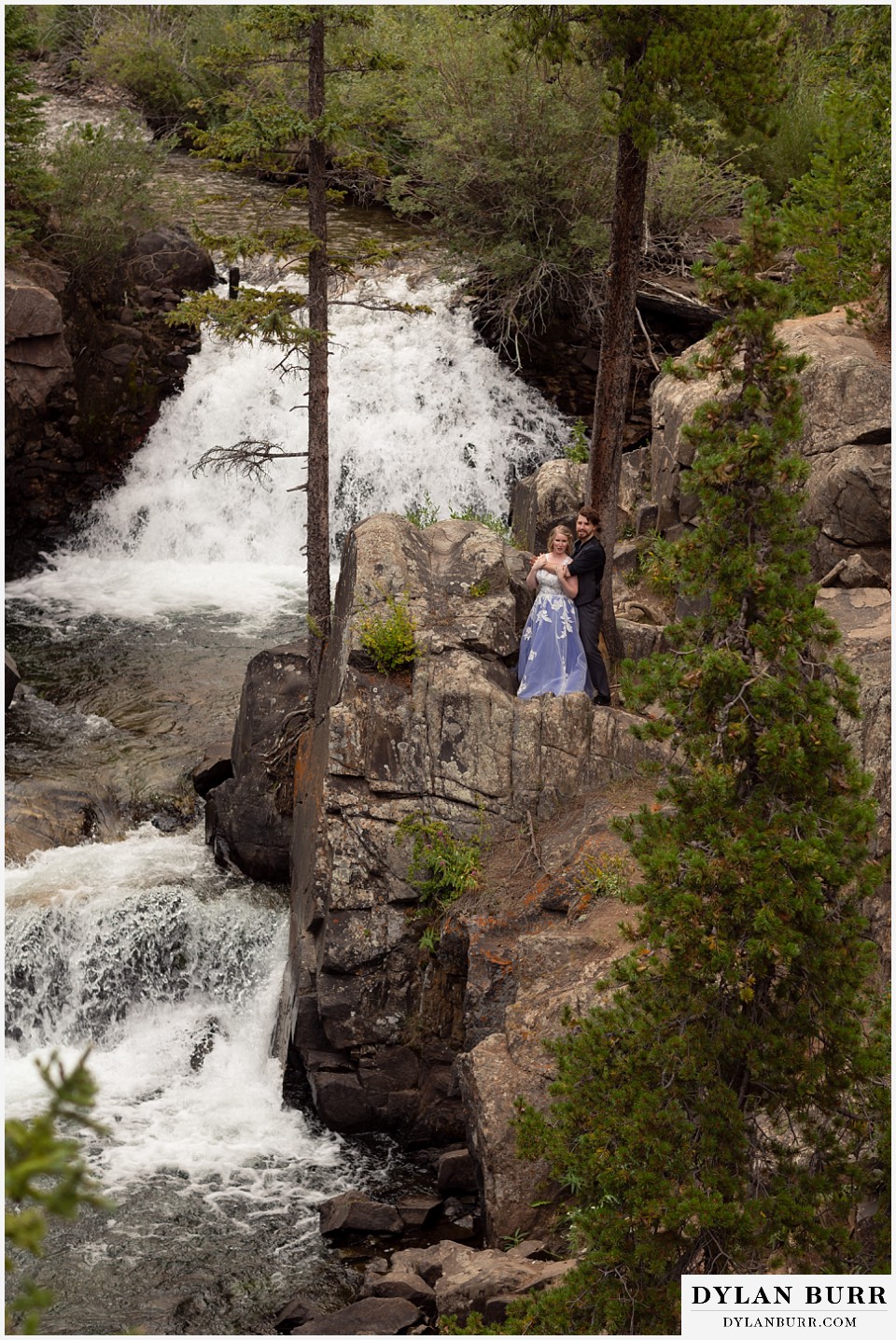 mountain adventure elopement wedding colorado large double waterfall of bride and groom together holding each other