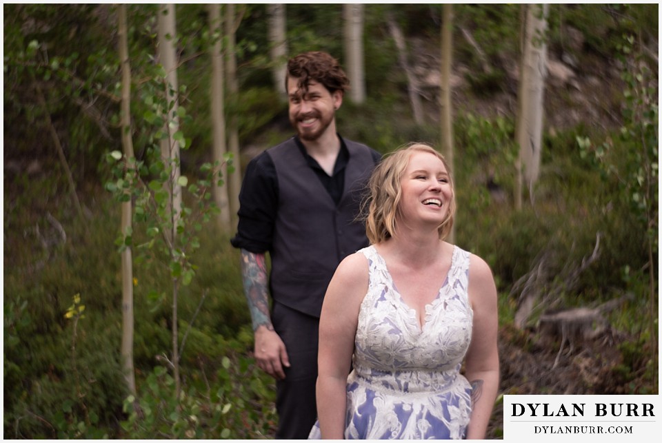 mountain adventure elopement wedding colorado bride and groom laughing after a serious moment