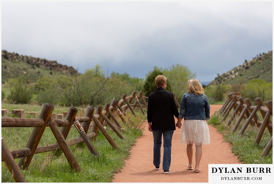 red rocks wedding morrison colorado couple walking down path together