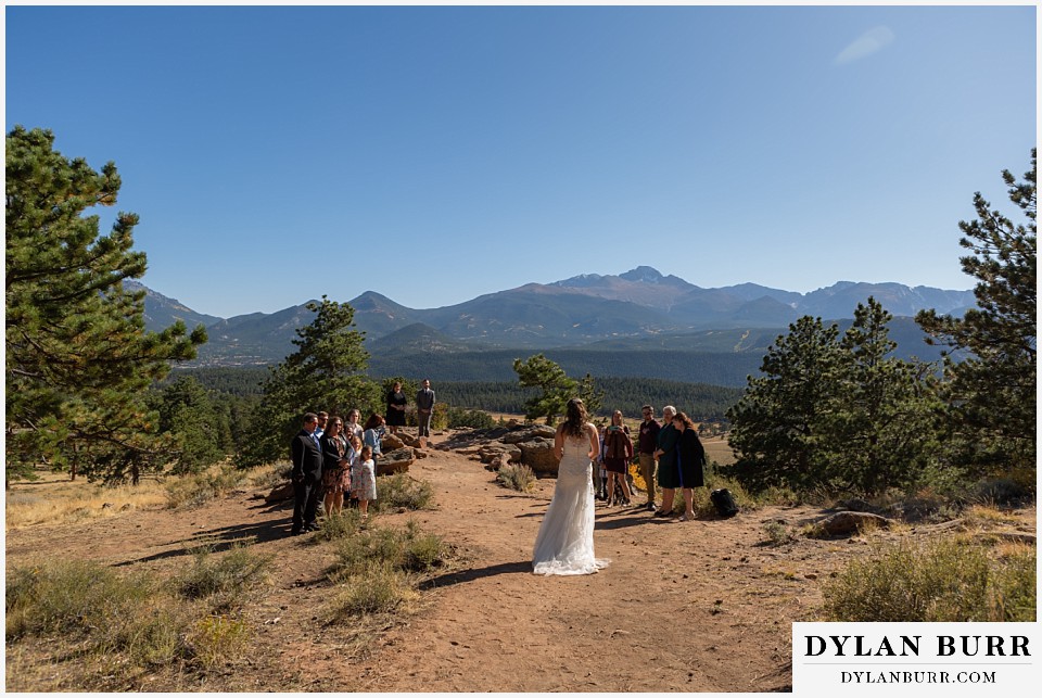 rocky mountain national park elopement wedding bride enters ceremony with family around her