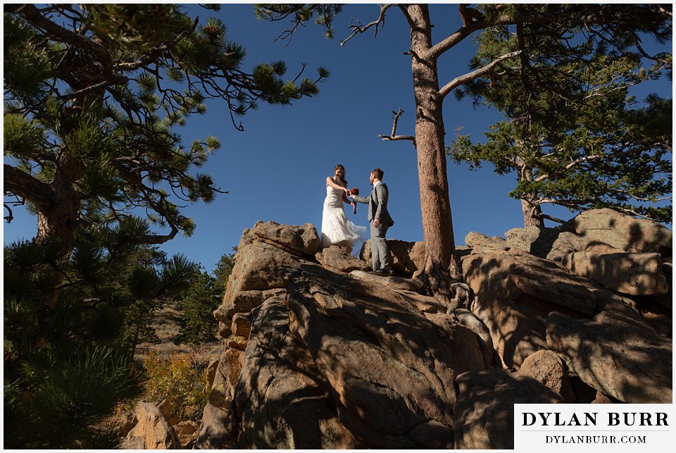 rocky mountain national park elopement wedding bride and groom hiking down mountain