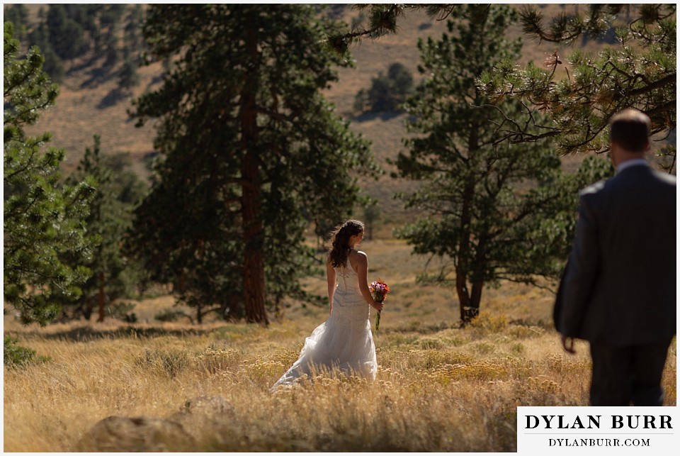 rocky mountain national park elopement wedding groom walking down hill to his bride
