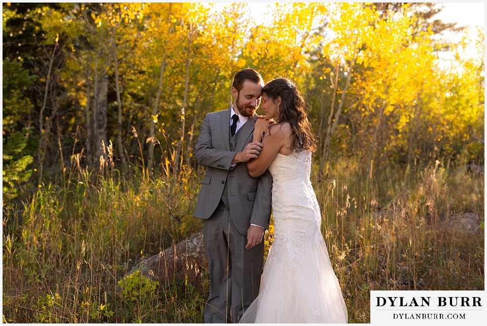 rocky mountain national park elopement wedding husband and wife close together in forest