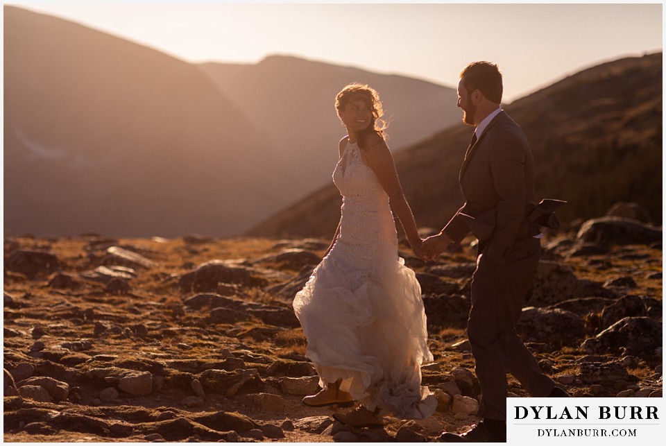 rocky mountain national park elopement wedding bride looking back at groom in alpine tundra