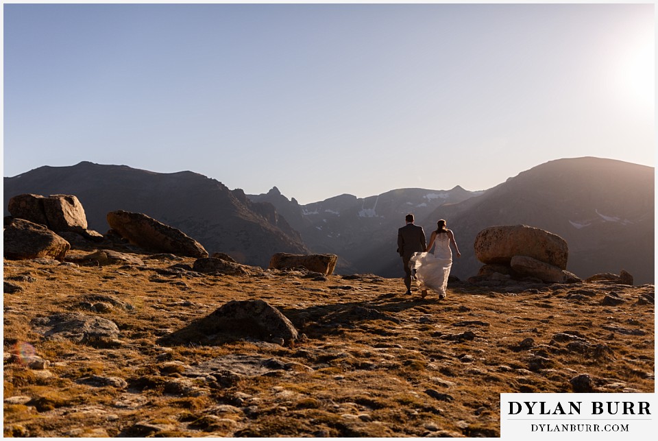 rocky mountain national park elopement wedding couple walking out to the mountain ledge
