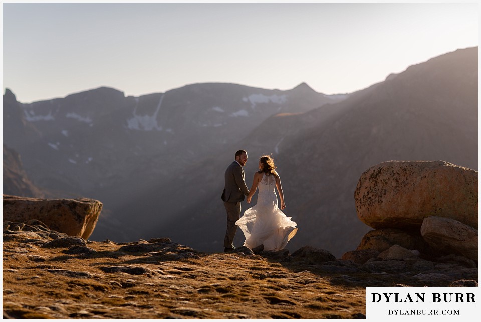 rocky mountain national park elopement wedding couple standing together in the mountain wind