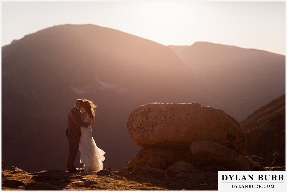 rocky mountain national park elopement wedding kissing in sunset glow