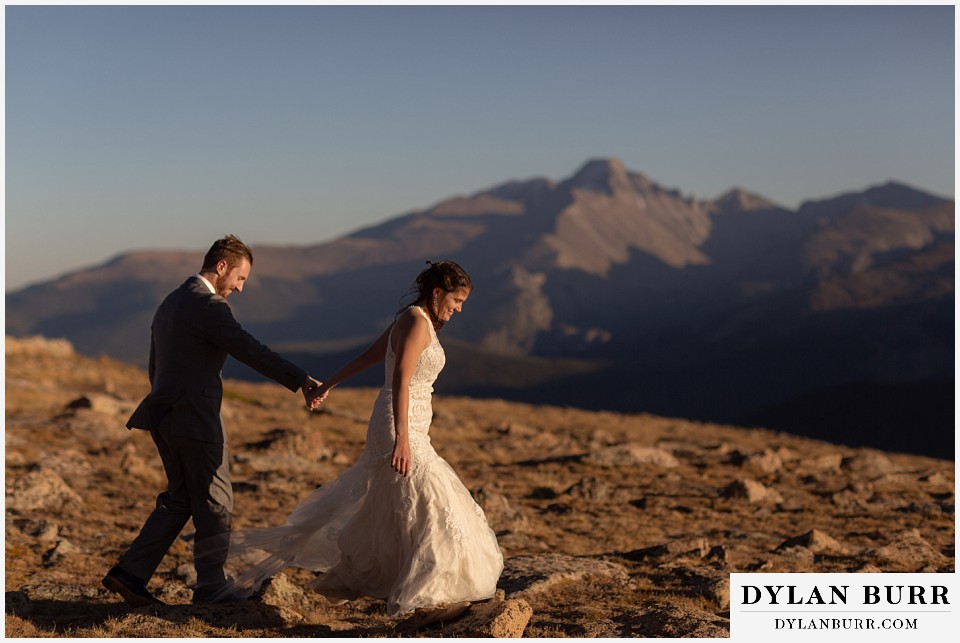 rocky mountain national park elopement wedding couple walking on rocks on mountain top