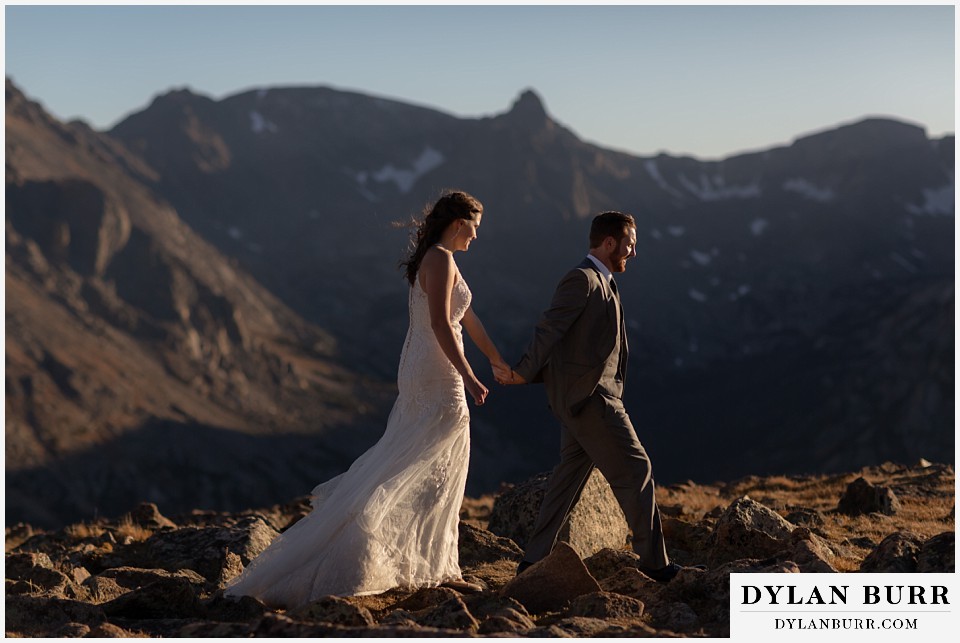 rocky mountain national park elopement wedding couple walking in snow capped mountain
