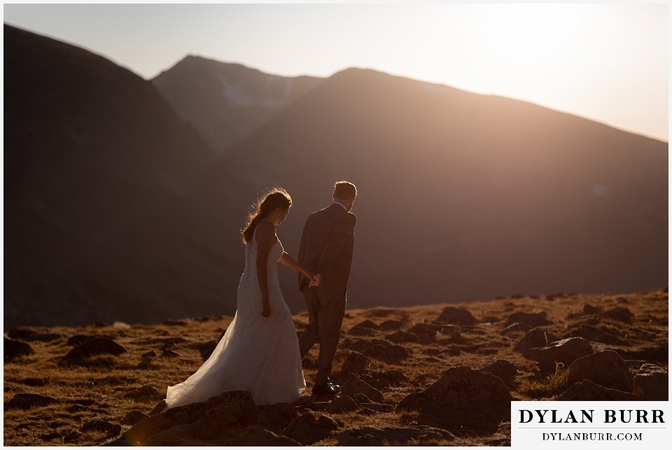 rocky mountain national park elopement wedding couple walking out into the sunset