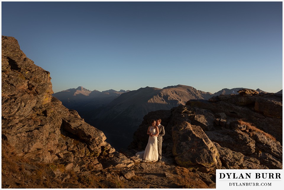 rocky mountain national park elopement wedding couple together in sunlight with long peak in the background