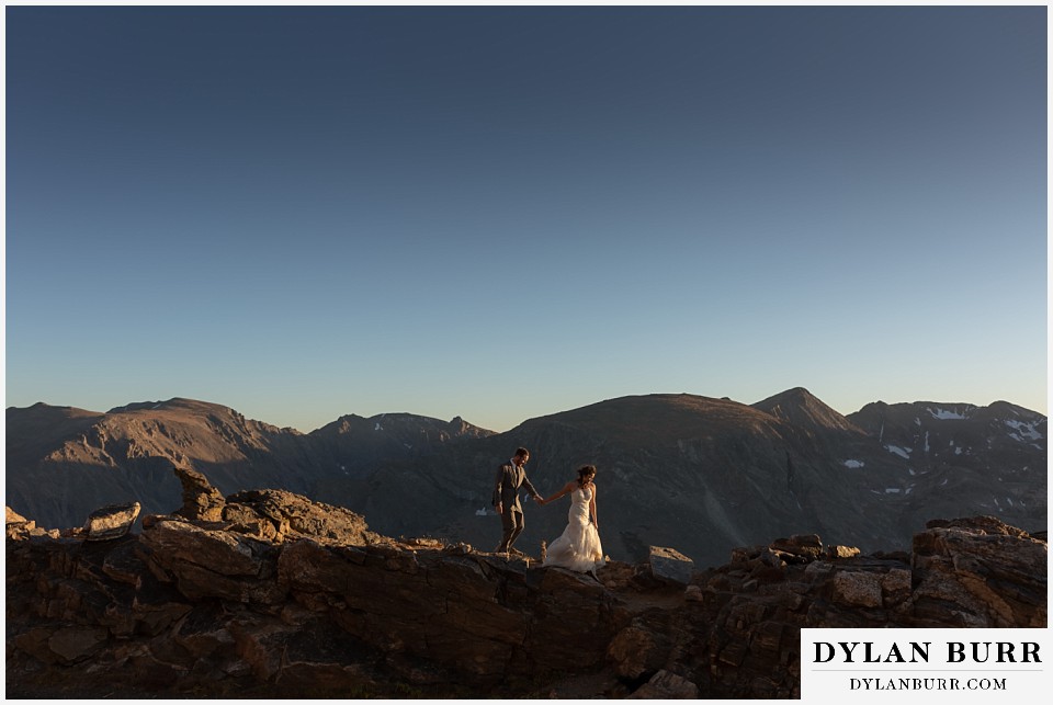 rocky mountain national park elopement wedding bride and groom walking along high mountain ridge