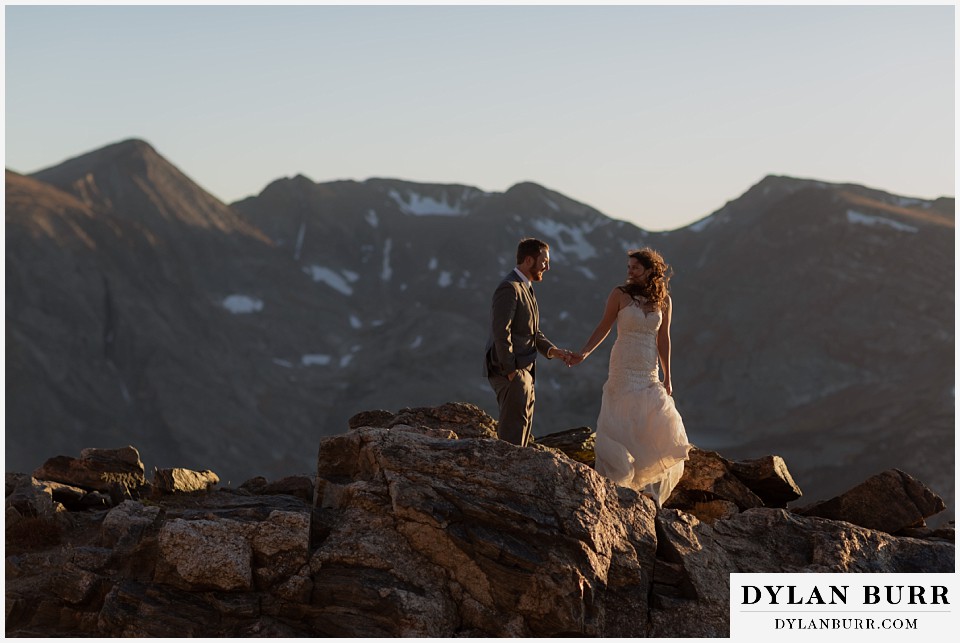 rocky mountain national park elopement wedding bride looking back at groom on mountain ridge