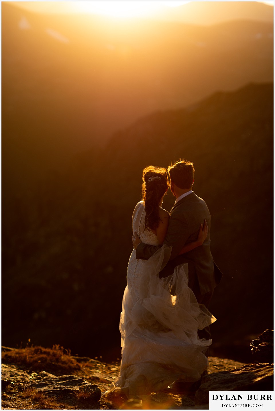 rocky mountain national park elopement wedding bride and groom holding each other in sunlight