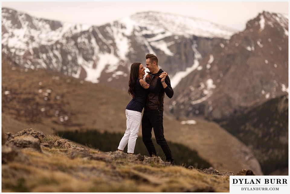 rocky mountain engagement session in colorado dancing with snow on mountains in background
