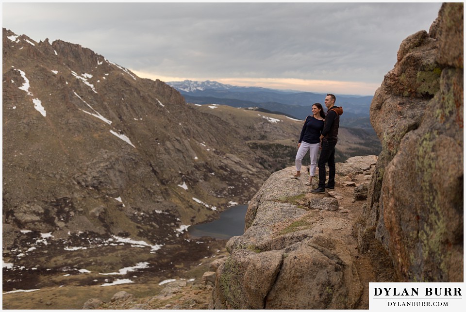 rocky mountain engagement session in colorado looking out over the mountain valley and lakes below