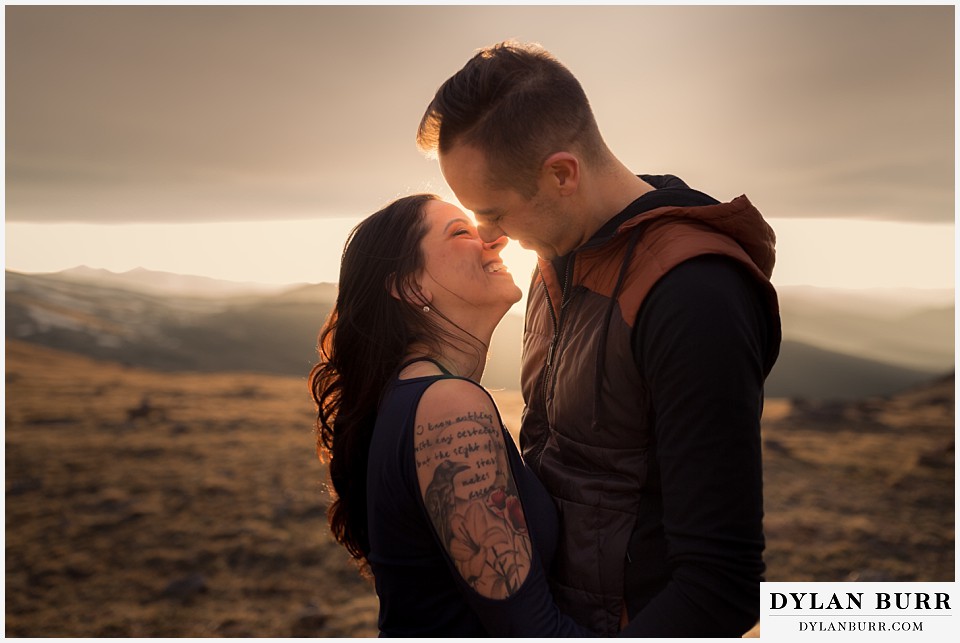 rocky mountain engagement session in colorado glowy sunset kiss
