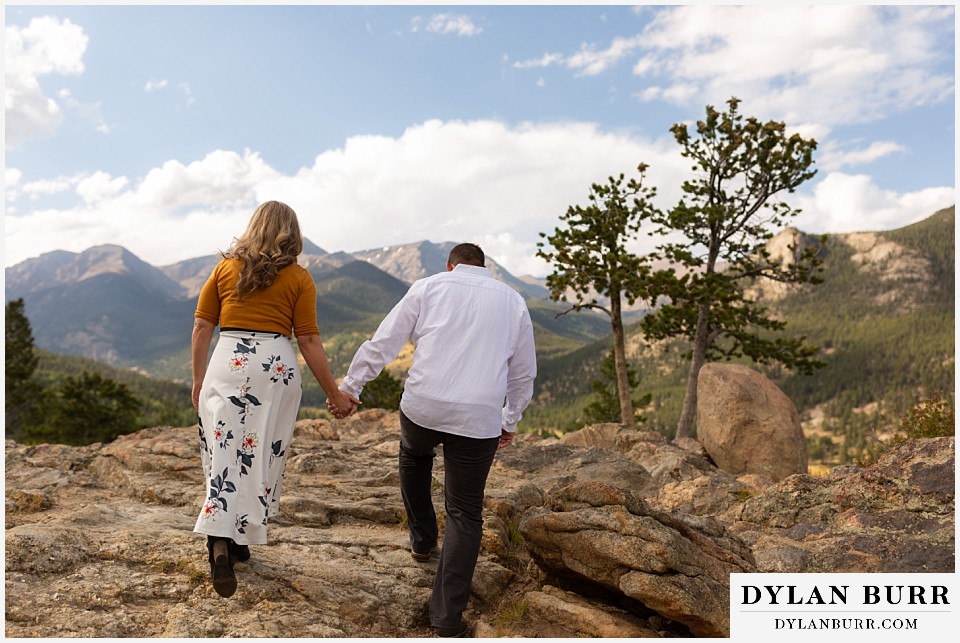 rocky mountain national park elopement wedding bride and groom hiking up hill