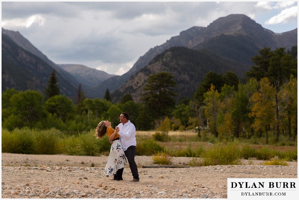 rocky mountain national park elopement wedding bride laughing as her groom picks her up
