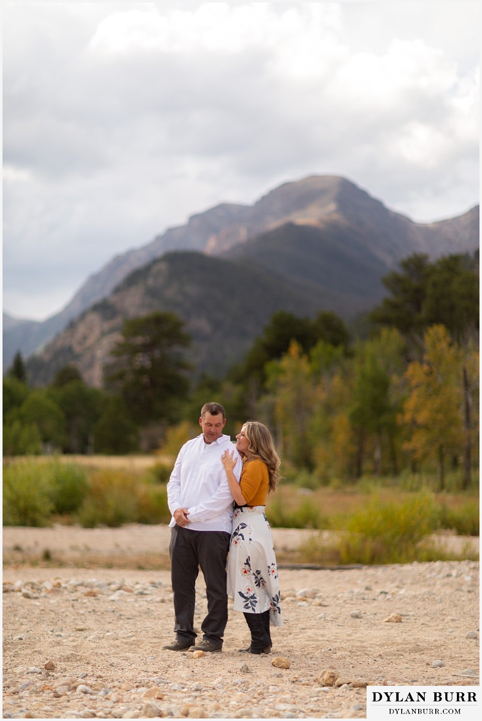 rocky mountain national park elopement wedding bride getting in close to groom with mountain in background
