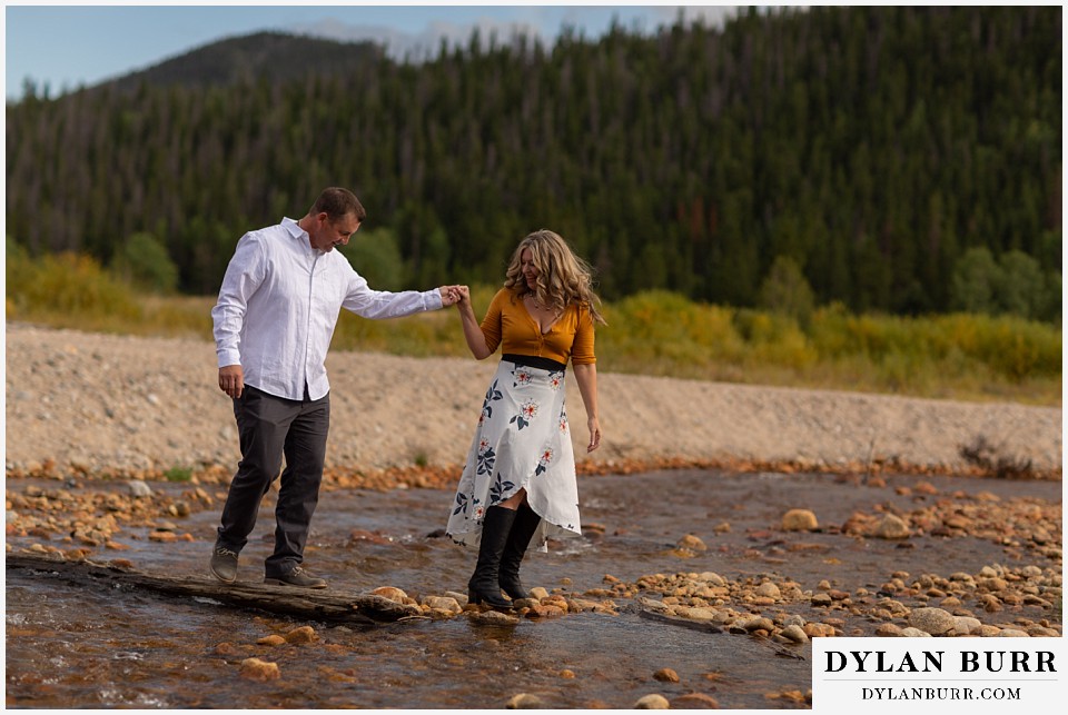 rocky mountain national park elopement wedding bride helping groom across river
