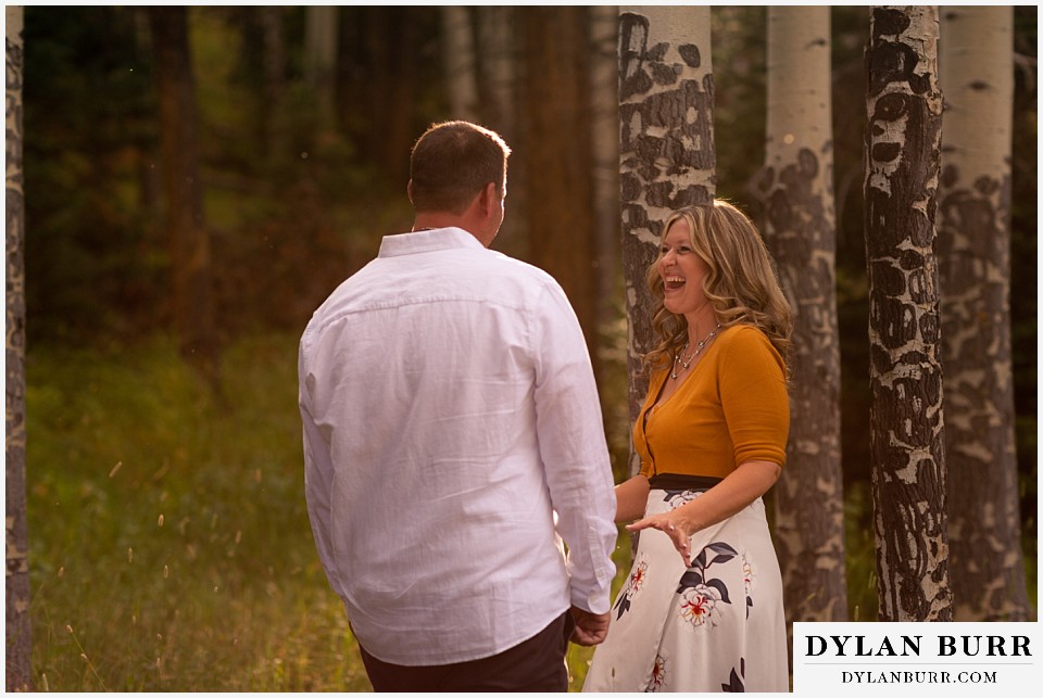 rocky mountain national park elopement wedding newlywed couple playing in trees and sunlight