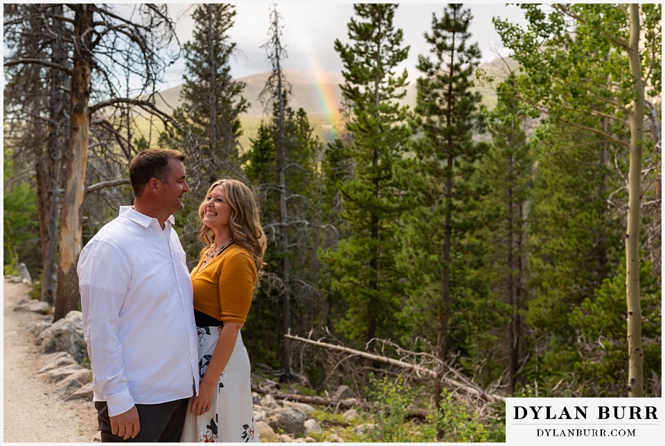 rocky mountain national park elopement wedding couple on hiking trail with rainbow in forest